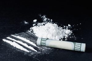 cocaine powder and rolled bill
